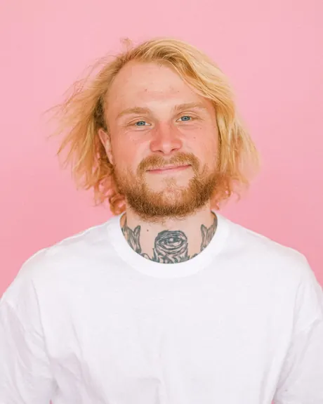 Smiling young man with a beard looking into the camera